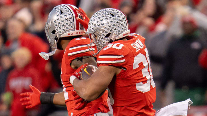 Nov 18, 2023; Columbus, Ohio, USA; 
Ohio State Buckeyes linebacker Cody Simon (30) and Ohio State Buckeyes linebacker C.J. Hicks (11) celebrate a defensive stop during the first half of their game against Minnesota Golden Gophers on Saturday, Nov. 18, 2023 at Ohio Stadium.