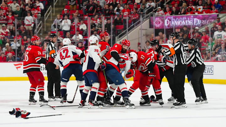 Apr 2, 2025; Raleigh, North Carolina, USA;  Carolina Hurricanes center Mark Jankowski (77) center Tyson Jost (27), defenseman Brent Burns (8), center Jesperi Kotkaniemi (82) and defenseman Sean Walker (26) battle Washington Capitals defenseman Martin Fehérváry (42),  defenseman Rasmus Sandin (38) and right wing Brandon Duhaime (22) during the third period at Lenovo Center. Mandatory Credit: James Guillory-Imagn Images