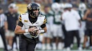 Aug 29, 2025; Charlotte, North Carolina, USA; Appalachian State Mountaineers quarterback AJ Swann (5) rolls out to pass against the Charlotte 49ers during the first quarter at Bank of America Stadium. Mandatory Credit: Jim Dedmon-Imagn Images