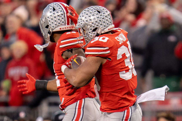 Linebackers celebrate after a play.