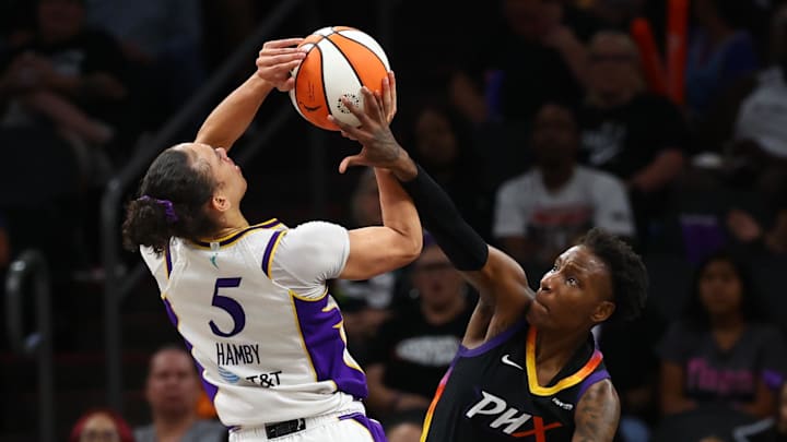 Sep 9, 2025; Phoenix, Arizona, USA; Los Angeles Sparks forward Dearica Hamby (5) is fouled by Phoenix Mercury forward Natasha Mack (4) during the second half of a WNBA game at PHX Arena. Mandatory Credit: Mark J. Rebilas-Imagn Images