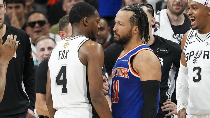 Jun 5, 2026; San Antonio, Texas, USA; San Antonio Spurs guard De'aaron Fox (4) and New York Knicks guard Jalen Brunson (11) exchange words during the fourth quarter during game two of the 2026 NBA Finals at Frost Bank Center. Mandatory Credit: Scott Wachter-Imagn Images
