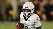 Nov 16, 2024; Ames, Iowa, USA; Cincinnati Bearcats wide receiver Tony Johnson (0) runs for a first down against the  Iowa State Cyclones in the second half at Jack Trice Stadium. The Iowa State Cyclones won the game 34-17.  Mandatory Credit: Reese Strickland-Imagn Images