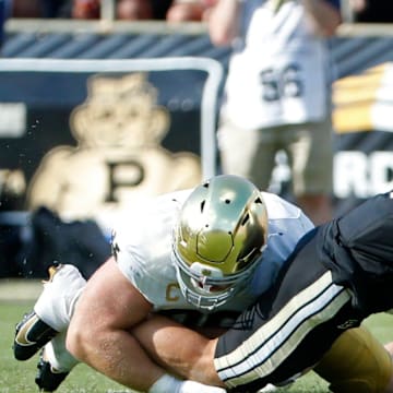 Purdue quarterback Hudson Card hit as his pass is intercepted by Notre Dame 