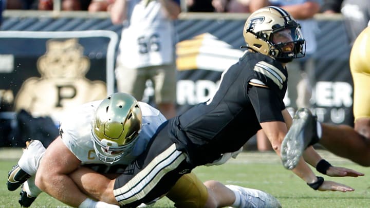 Purdue quarterback Hudson Card hit as his pass is intercepted by Notre Dame 