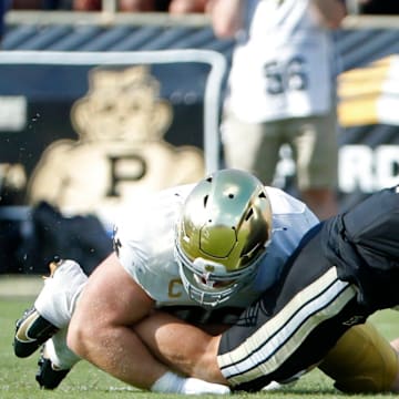 Purdue Boilermakers quarterback Hudson Card (1) is hit as his pass is intercepted by Notre Dame Fighting Irish defensive lineman Boubacar Traore (5) Saturday, Sept. 14, 2024, during the NCAA football game at Ross-Ade Stadium in West Lafayette, Ind.