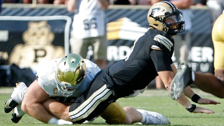 Purdue Boilermakers quarterback Hudson Card (1) is hit as his pass is intercepted by Notre Dame Fighting Irish defensive lineman Boubacar Traore (5) Saturday, Sept. 14, 2024, during the NCAA football game at Ross-Ade Stadium in West Lafayette, Ind.