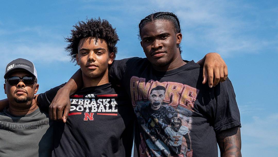 From left to right, Donald Tabron II, 16, Donovan Dooley, 40, owner and founder of Quarterback University, Trae Taylor, 16, and Bryce Underwood, 17, take a photo together after participating in a private workout in Detroit on Saturday, June 21, 2025.