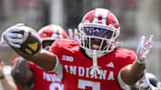 Sep 6, 2025; Bloomington, Indiana, USA; Indiana Hoosiers defensive lineman Kellan Wyatt (13) and defensive back Louis Moore (7) celebrate after forcing a turnover during the second half against the Kennesaw State Owls at Memorial Stadium. 