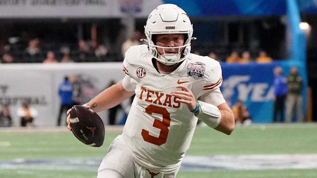 Jan 1, 2025; Atlanta, GA, USA; Texas Longhorns quarterback Quinn Ewers (3) runs with the ball for a touchdown against the Arizona State Sun Devils during the second half of the Peach Bowl at Mercedes-Benz Stadium