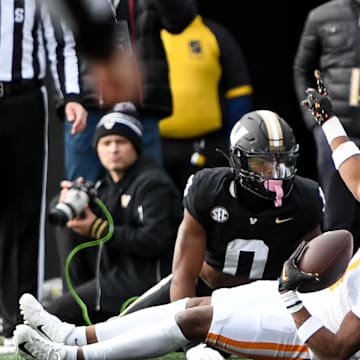 Nov 30, 2024; Nashville, Tennessee, USA;  Tennessee Volunteers defensive back Jermod McCoy (3) intercepts the pass thrown to Vanderbilt Commodores wide receiver Junior Sherrill (0) during the first half at FirstBank Stadium. Mandatory Credit: Steve Roberts-Imagn Images