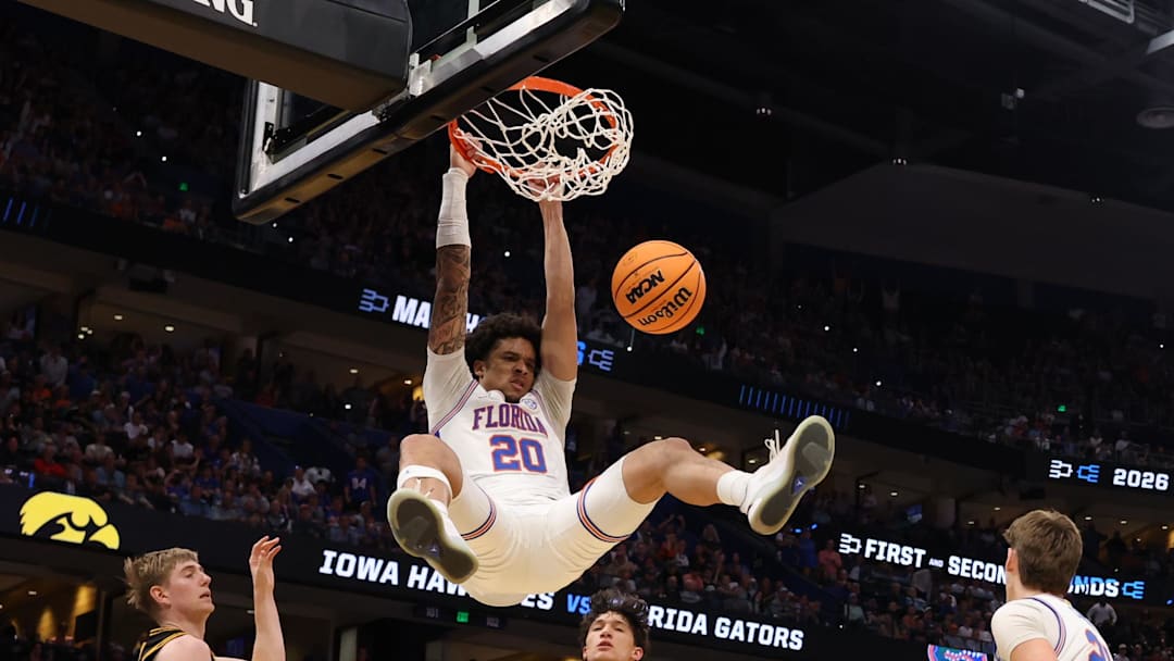 Mar 22, 2026; Tampa, FL, USA; Florida Gators guard Isaiah Brown (20) dunks the ball past Iowa Hawkeyes forward Cooper Koch (8) in the second half during a second round game of the men's 2026 NCAA Tournament at Benchmark International Arena. Mandatory Credit: Matt Pendleton-Imagn Images