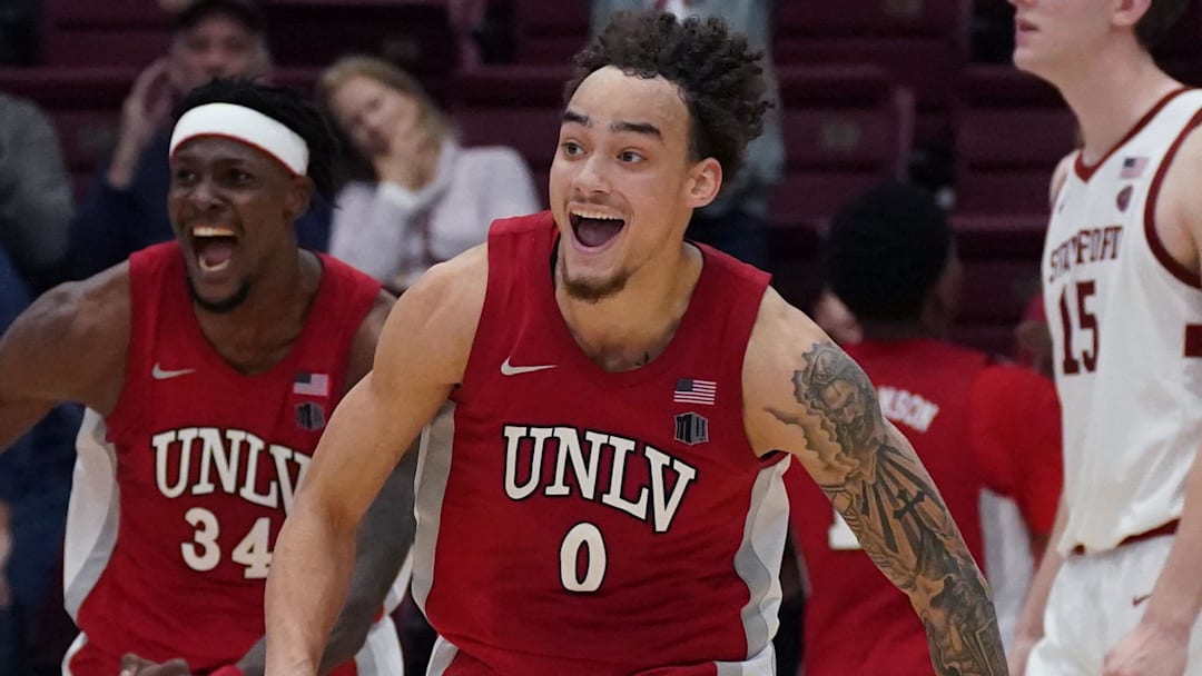 UNLV Runnin' Rebels guard Dra Gibbs-Lawhorn (0) and center Emmanuel Stephen (34) celebrate after the buzzer sounds as Stanford Cardinal forward/center Oskar Giltay (15) looks on in the second half at Maples Pavilion. Mandatory Credit: David Gonzales-Imagn Images