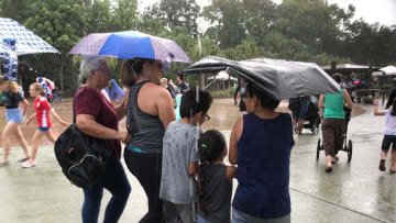Rain starts to fall (and wind whips an umbrella!) at Animal Kingdom Saturday. Whether they were