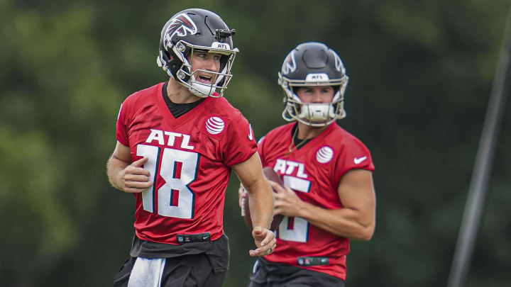 Jul 25, 2024; Buford, GA, USA; Atlanta Falcons quarterback Kirk Cousins (18) and quarterback John Paddock (16) on the field on the first day of training camp at Falcons Training Camp.