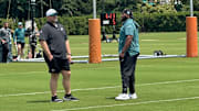 Eagles senior personnel director Joe Douglas chats with assistant OL coach Greg Austin.