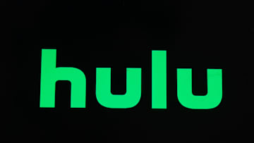 In this photo illustration a Hulu logo seen displayed on a...