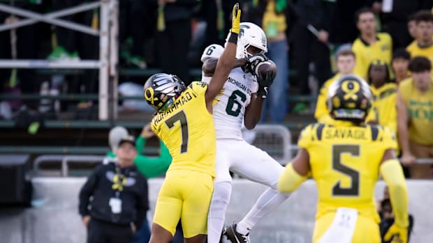 Michigan State Spartans wide receiver Nick Marsh hauls in a pass under coverage from Oregon Ducks defensive back Jabbar Muham