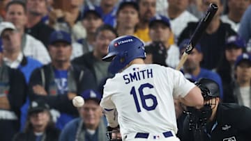 Los Angeles Dodgers catcher Will Smith (16) is hit by a pitch during the 10th inning Monday against the Toronto Blue Jays in game three of the 2025 MLB World Series at Dodger Stadium.