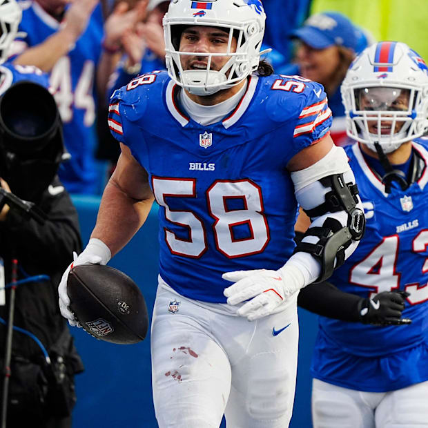 Buffalo Bills linebacker Matt Milano is all smiles as he heads towards the bench with the ball
