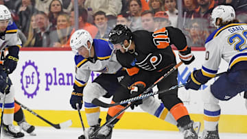 Oct 31, 2024; Philadelphia, Pennsylvania, USA; St. Louis Blues center Dylan Holloway (81) and Philadelphia Flyers right wing Tyson Foerster (71) battle for the puck during the second period at Wells Fargo Center.