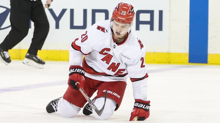 Jan 28, 2025; New York, New York, USA;  Carolina Hurricanes center Sebastian Aho (20) gets up off the ice after getting knocked down on a crosscheck in the second period against the New York Rangers at Madison Square Garden. Mandatory Credit: Wendell Cruz-Imagn Images
