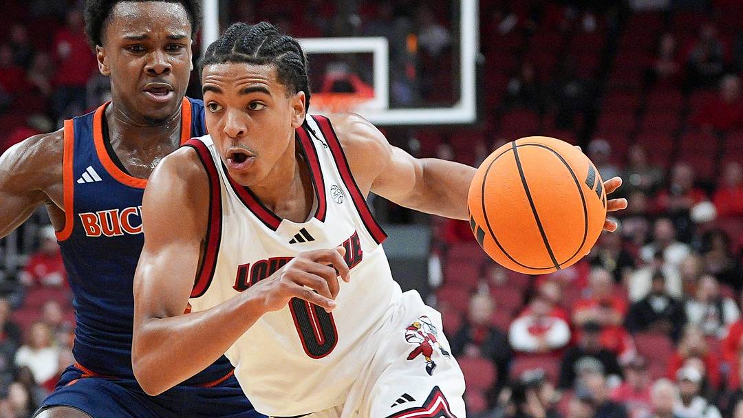 Louisville Cardinals guard Mikel Brown Jr. (0) drives by Bucknell Bison guard Jayden Williams (2) during an exhibition game at the KFC Yum! Center in Louisville, Kentucky Tuesday October 28, 2025.
