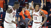 Jan 2, 2021; Champaign, Illinois, USA; Illinois Fighting Illini center Kofi Cockburn (21) and guard Ayo Dosunmu (11) celebrate during the first half against the Purdue Boilermakers at the State Farm Center. Mandatory Credit: Patrick Gorski-Imagn Images