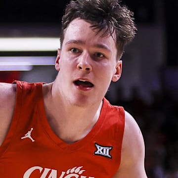 Mar 5, 2025; Cincinnati, Ohio, USA; Cincinnati Bearcats guard Simas Lukosius (41) dribbles against Kansas State Wildcats guard C.J. Jones (3) in the first half at Fifth Third Arena. Mandatory Credit: Katie Stratman-Imagn Images