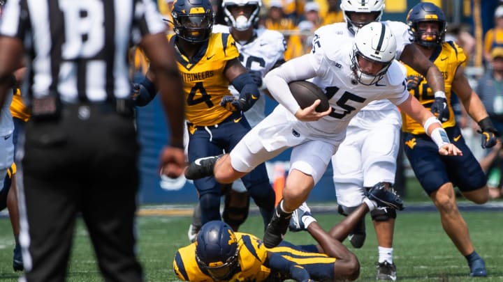 Penn State quarterback Drew Allar (15) runs up the middle in the first half of an NCAA football game against West Virginia, Saturday, August 31, 2024, in Morgantown, W. Va.