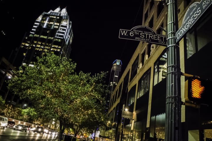 Street sign in Austin, Texas, reading "W. 6th Street"