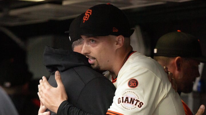 Jul 27, 2024; San Francisco, California, USA; San Francisco Giants starting pitcher Blake Snell (right) hugs pitching coach Brian Price after pitching six shutout innings against the Colorado Rockies at Oracle Park