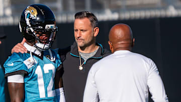 Jacksonville Jaguars wide receiver Travis Hunter (12) talks with Jaguars Defensive Coordinator Anthony Campanile, center and Jaguars Secondary Coach Ron Mills during an NFL training camp second session at the Miller Electric Center, Thursday, July 24, 2025, in Jacksonville, Fla. 