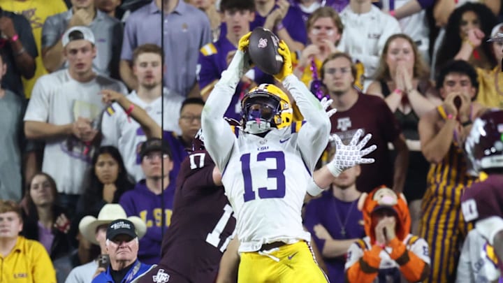 Oct 25, 2025; Baton Rouge, Louisiana, USA; Louisiana State Tigers defensive back A.J. Haulcy (13) makes an interception against Texas A&M Aggies tight end Theo Melin Öhrström (17) during the first half at Tiger Stadium. Mandatory Credit: Stephen Lew-Imagn Images