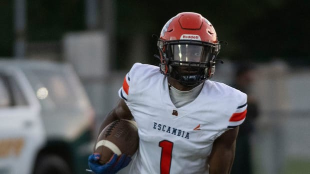 Escambia High School's Ladarian Clardy ( No.1) runs for positive yards during Friday night's season opener against West Flori