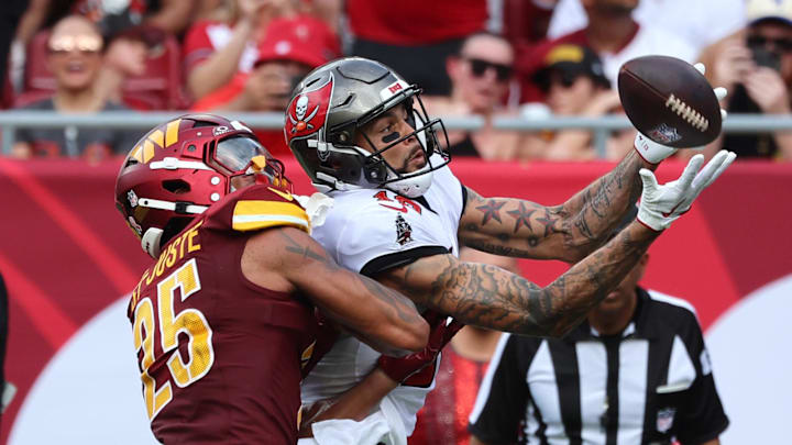 Sep 8, 2024; Tampa, Florida, USA;  Tampa Bay Buccaneers wide receiver Mike Evans (13) catches the ball for a touchdown over Washington Commanders cornerback Benjamin St-Juste (25) during the first half at Raymond James Stadium. Mandatory Credit: Kim Klement Neitzel-Imagn Images