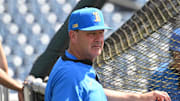 Jun 14, 2025; Omaha, Neb, USA;  UCLA Bruins head coach John Savage watches the team warm up before the game against the Murray State Races at Charles Schwab Field. Mandatory Credit: Steven Branscombe-Imagn Images