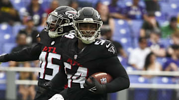 Aug 17, 2024; Baltimore, Maryland, USA;  Atlanta Falcons linebacker Donavan Mutin (45) and defensive tackle Brandon Dorlus (54) celebrate recovering a Baltimore Ravens fumble during the first half at M&T Bank Stadium. Mandatory Credit: Tommy Gilligan-Imagn Images