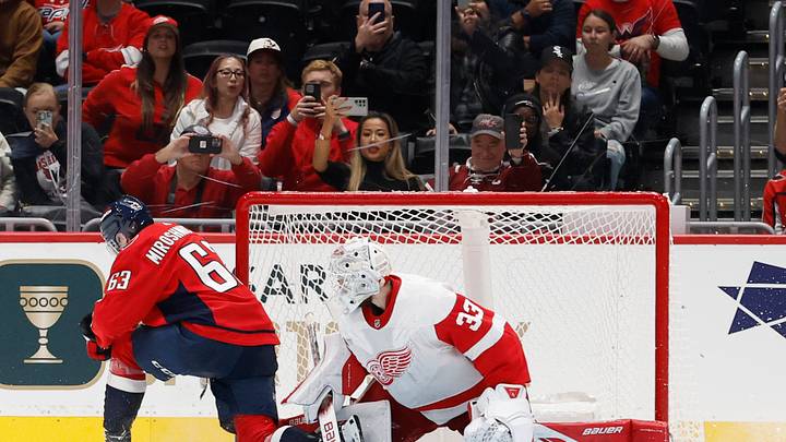 Sep 28, 2023; Washington, District of Columbia, USA; Detroit Red Wings goaltender Sebastian Cossa (33) makes a save on Washington Capitals left wing Ivan Miroshnichenko (63) during a shootout at Capital One Arena. Mandatory Credit: Geoff Burke-USA TODAY Sports