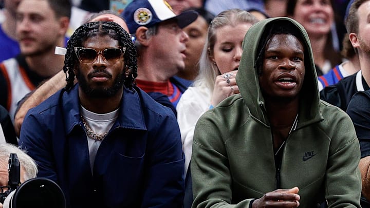 Colorado quarterback Shedeur Sanders and wide receiver/cornerback Travis Hunter sit court side at a Denver Nuggets game in 2023.