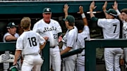 Michigan State's Noah Bright, left, celebrates his score with head coach Jake Boss Jr., center, and the dugout during the eighth inning in the game against Ohio State on Friday, April 18, 2025, at McLane Stadium in East Lansing.