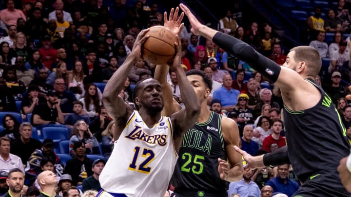 Los Angeles Lakers forward Taurean Prince (12) drives to the basket against New Orleans Pelicans center Jonas Valanciunas (17) during the second half at Smoothie King Center. 