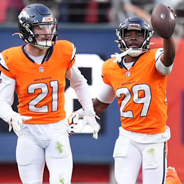 Oct 27, 2024; Denver, Colorado, USA; Denver Broncos cornerback Ja'Quan McMillian (29) celebrates his turnover with cornerback Riley Moss (21) in the second half against the Carolina Panthers at Empower Field at Mile High. 