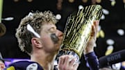 Michigan quarterback J.J. McCarthy kisses the trophy to celebrate winning the national championship game.