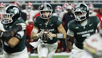 Michigan State Spartans quarterback Alessio Milivojevic (11) rolls out and looks to throw during a game against the Maryland Terrapins at Ford Field in Detroit on Saturday, Nov. 29, 2025.