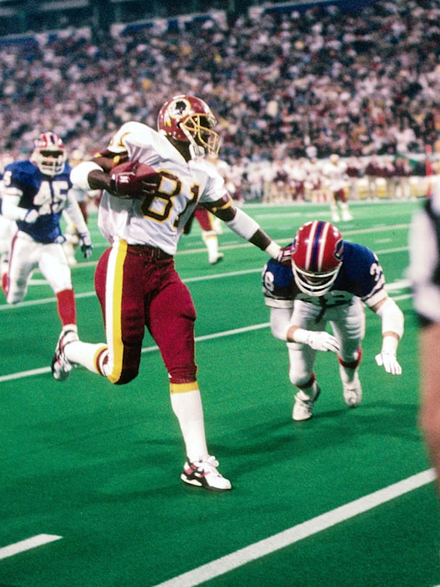 Washington Redskins receiver (81) Art Monk tries to elude Buffalo Bills safety (38) Mark Kelso during Super Bowl XXVI.