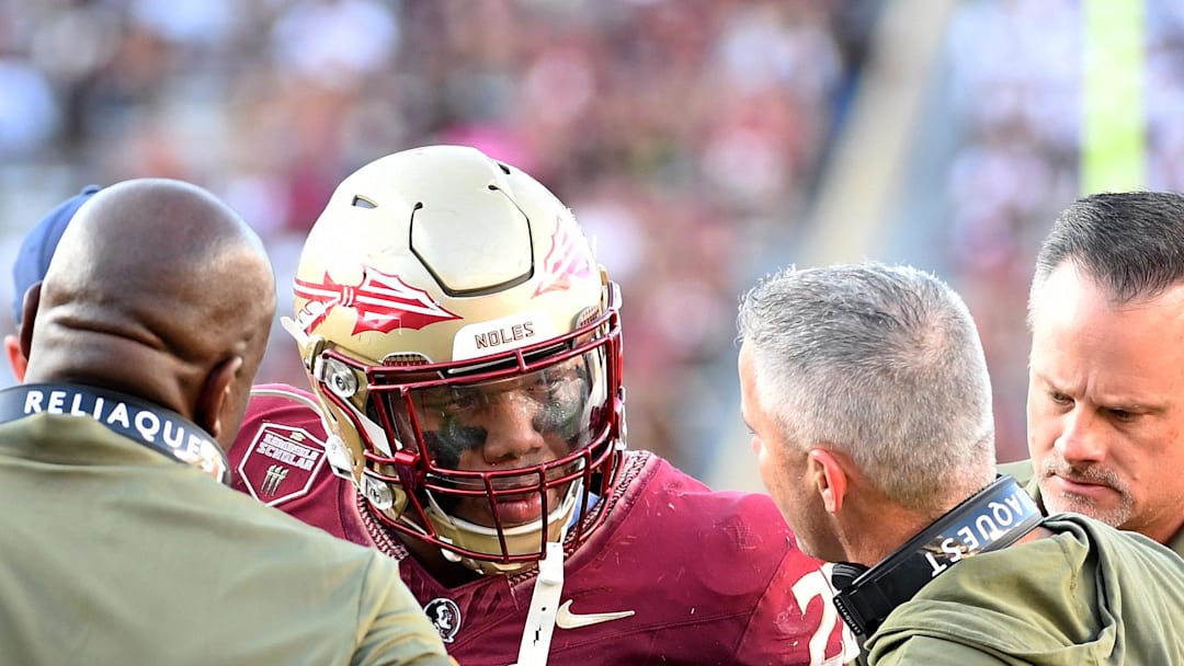 Nov 2, 2024; Tallahassee, Florida, USA; Florida State Seminoles linebacker Justin Cryer (28) talks to head coach Mike Norvell after suffering an apparent injury in the third quarter against the North Carolina Tarheels at Doak S. Campbell Stadium. Mandatory Credit: Robert Myers-Imagn Images