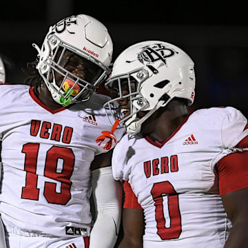 Vero Beach's Dontallis Render (19) celebrates a sack with teammate Maqarie Philip (0) in a game against Port St. Lucie on Oct. 24, 2025. The unbeaten Indians (11-0) rushed St. Johns Creekside, 57-19, in a Class 7A regional quarterfinal game on Nov. 14, 2025.