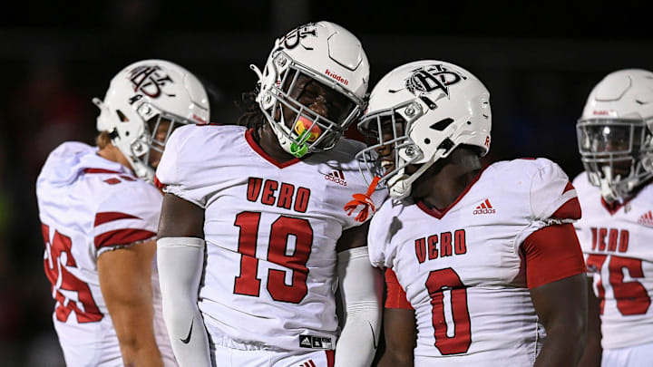 Vero Beach's Dontallis Render (19) celebrates a sack with teammate Maqarie Philip (0) in a game against Port St. Lucie on Oct. 24, 2025. The unbeaten Indians (11-0) rushed St. Johns Creekside, 57-19, in a Class 7A regional quarterfinal game on Nov. 14, 2025.