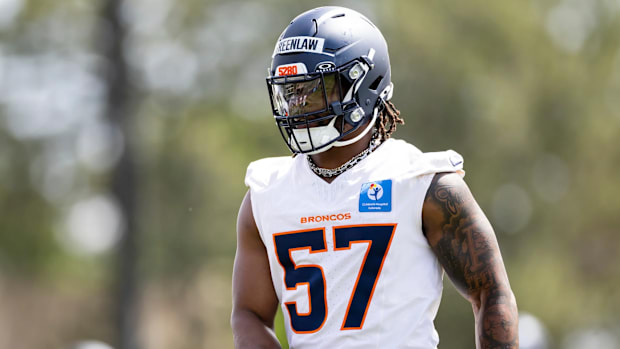 Denver Broncos linebacker Dre Greenlaw (57) works out during mandatory minicamp. 